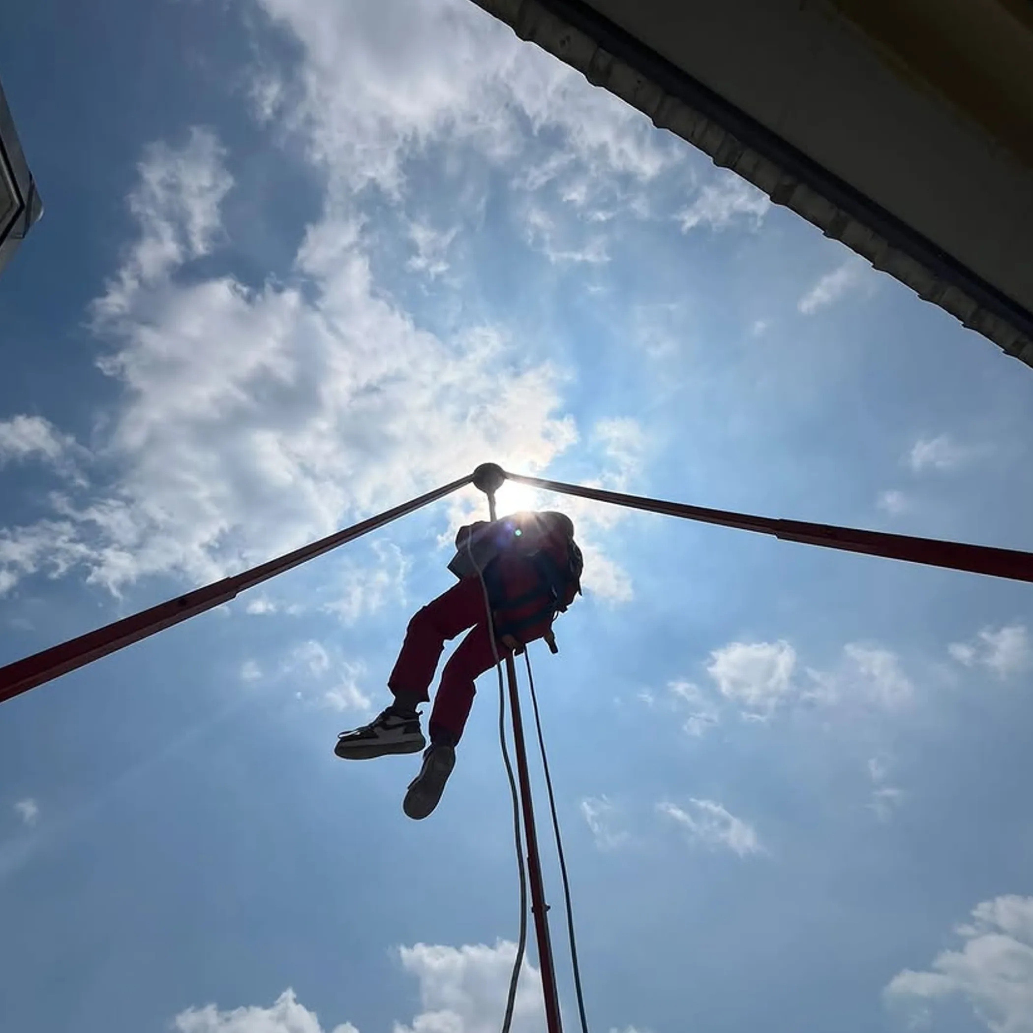worker using ropes and safety equipment