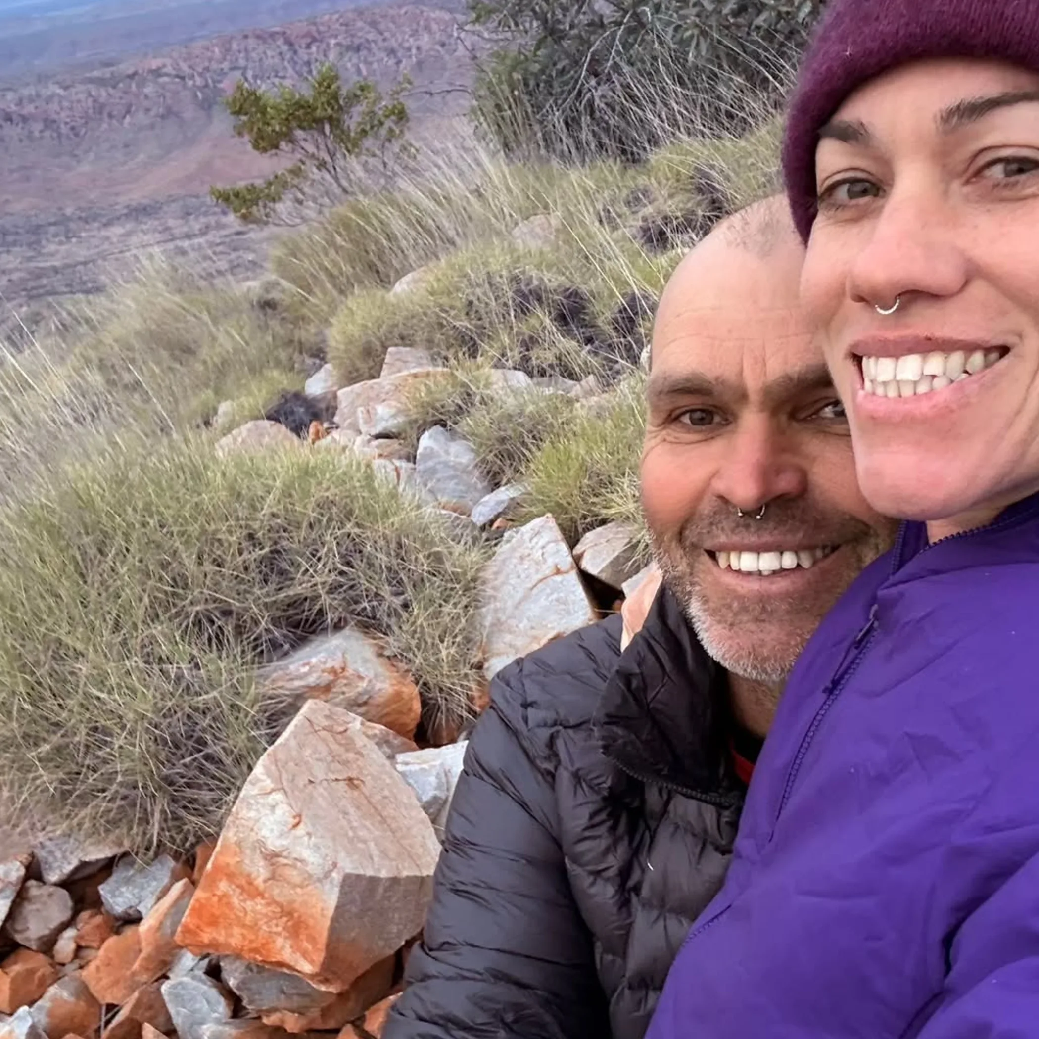 hikers in rocky central australian landscape
